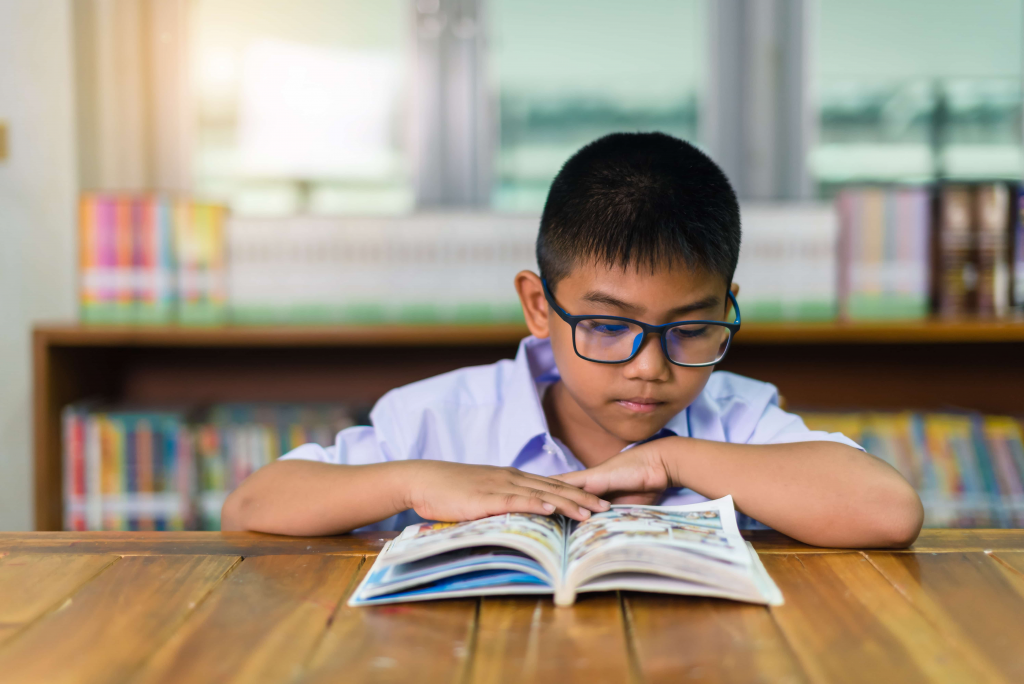 kindergarten child reading simple book independently ages 5 to 6 reading milestone