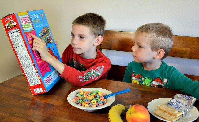 child looking at cereal box practicing letter sounds