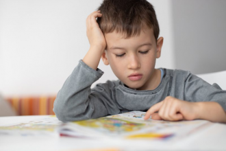 child staring blankly at book unable to understand what they read