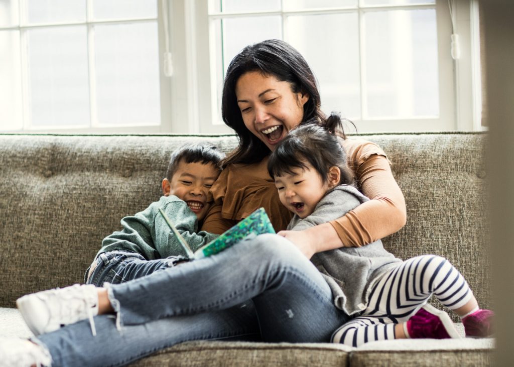 parent and child sitting together using free reading tools and books at home