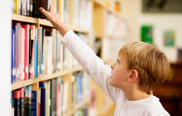 Child choosing books during reading routine