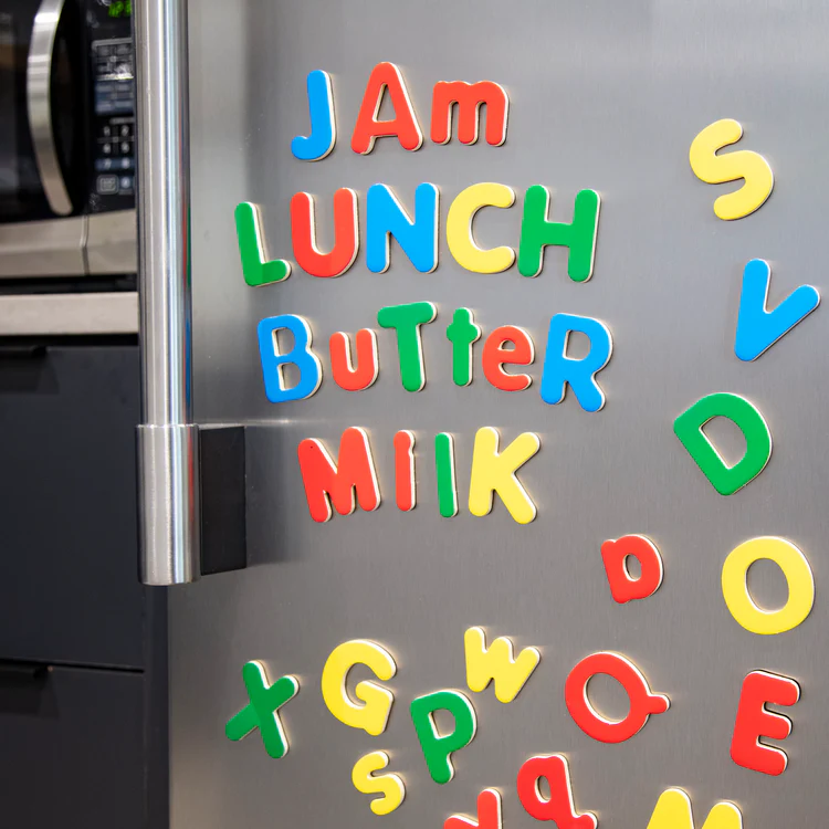 colorful magnetic letters on refrigerator for word spelling activity 