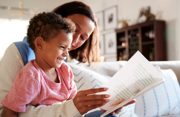 child reading aloud from book to improve reading fluency at home
