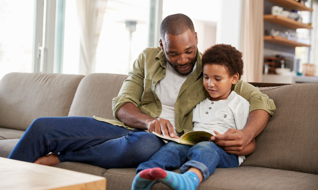 parent reading aloud with child at home to model reading fluency