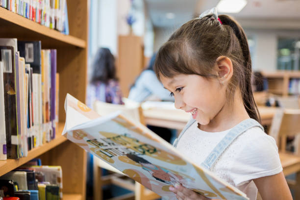happy child reading book independently after improving reading fluency