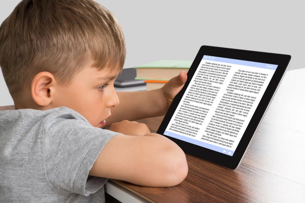 Child using a digital reading tool on a tablet at home