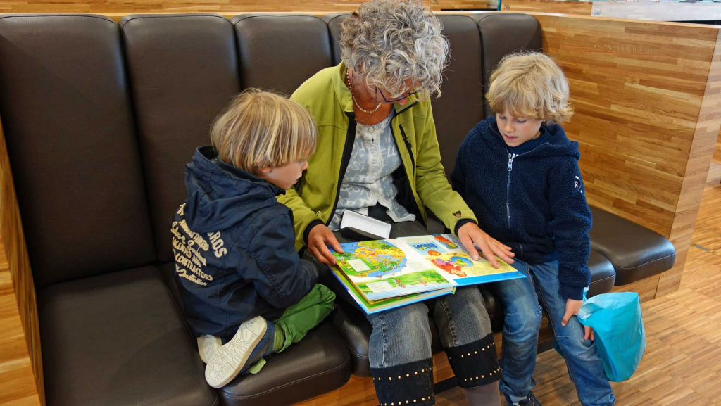 parent reading a children's book with a child