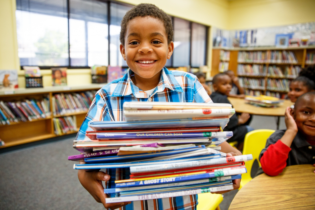 child choosing books from a library shelf