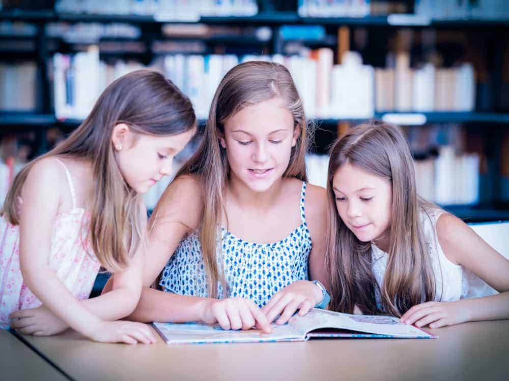 child of different ages rereading favorite books at home, illustrating reading development stages