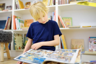 Child reading a graphic novel and children's books