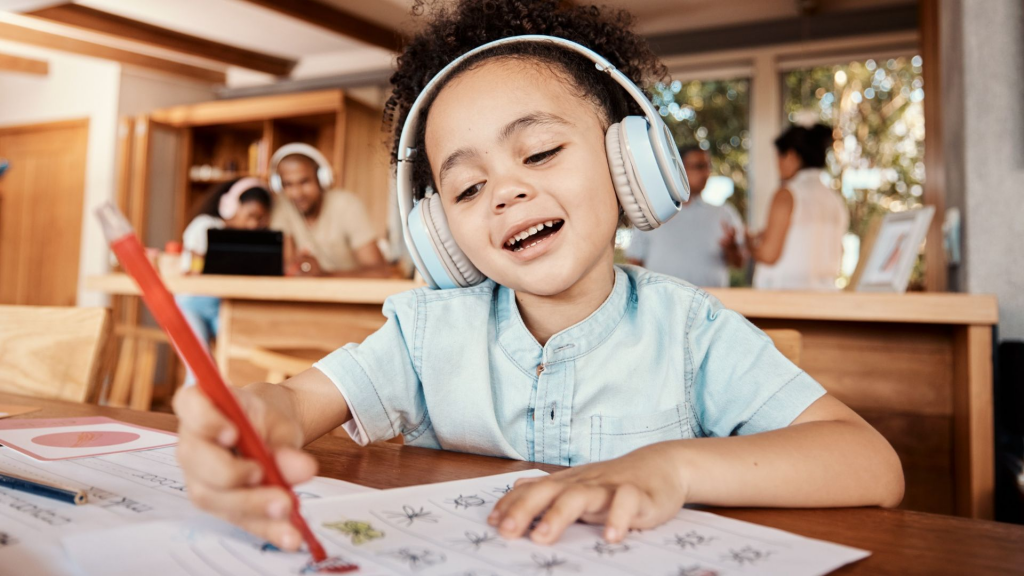 Child listening to an audiobook while following along with a book