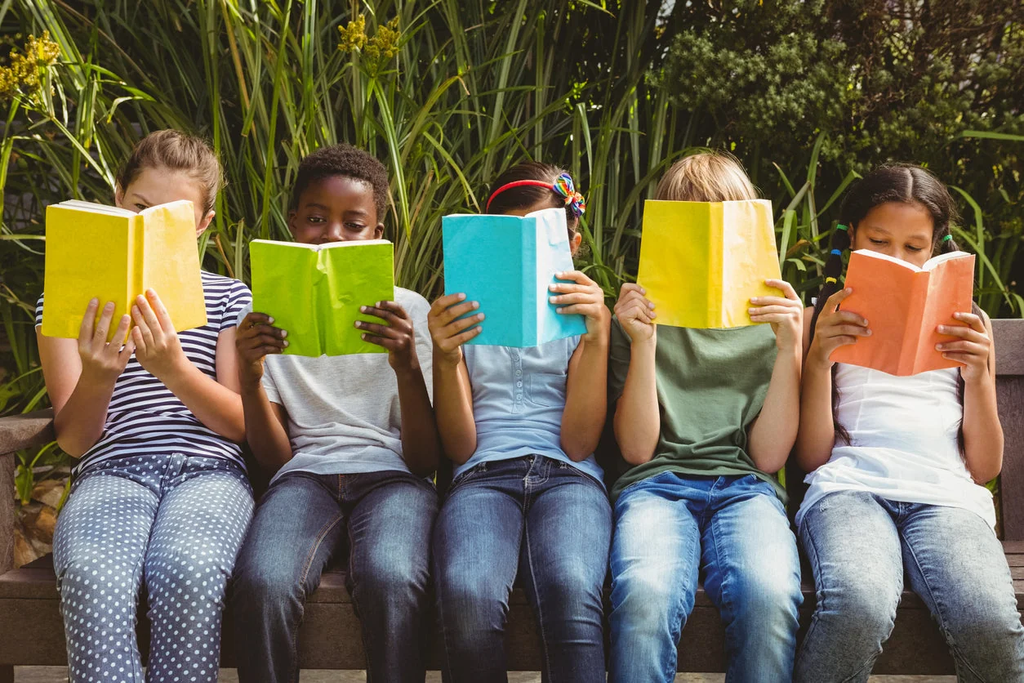 Children reading books together in a classroom
