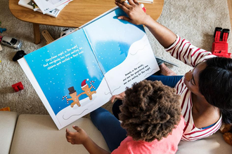 Parent reading aloud to kids at home
