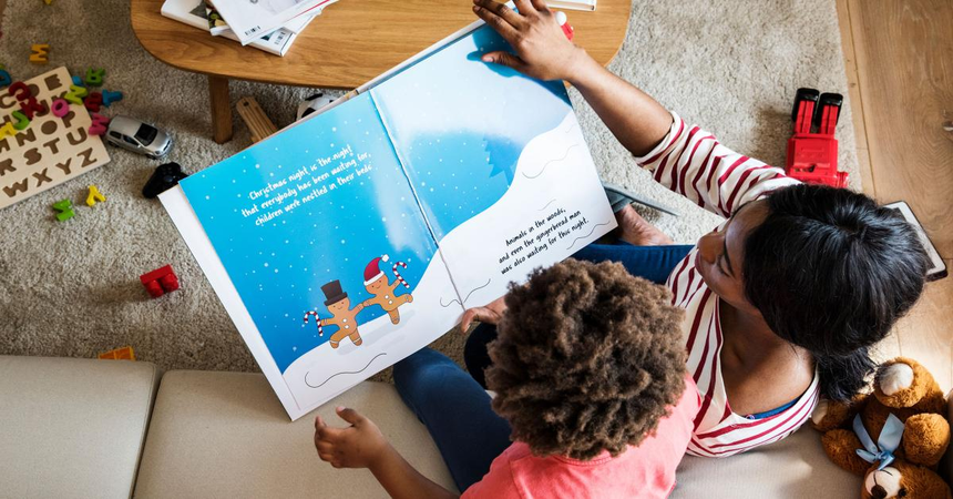 Parent reading aloud to kids at home
