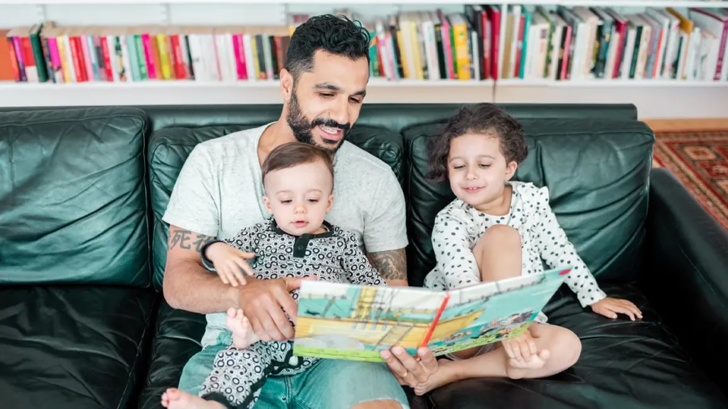 Parent reading a picture book aloud to kids
