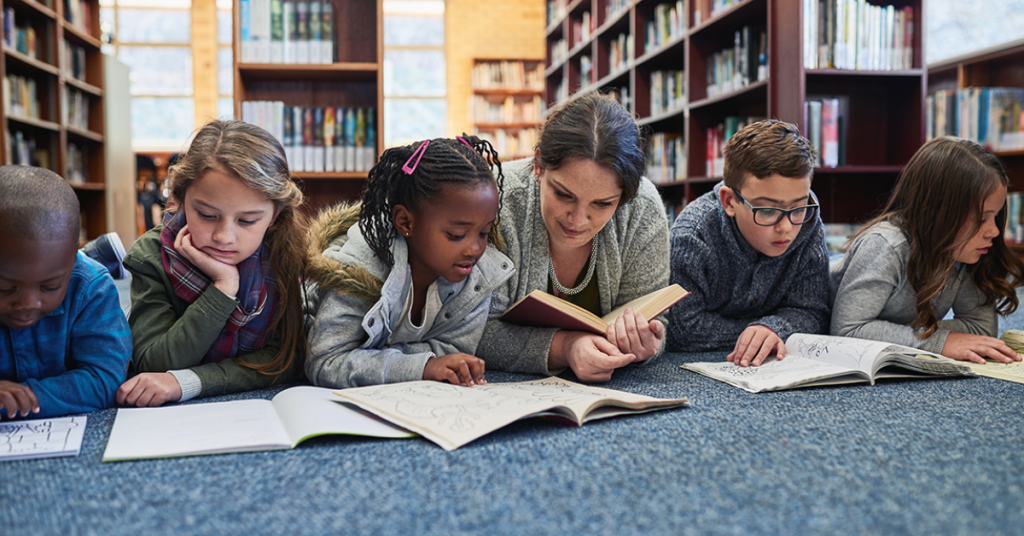 Elementary students reading books at different grade levels