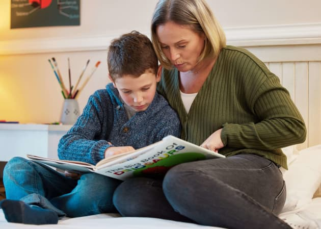 Parent and child reading a nonfiction book together