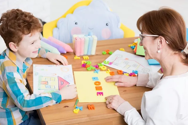 Child writing new vocabulary words in a notebook