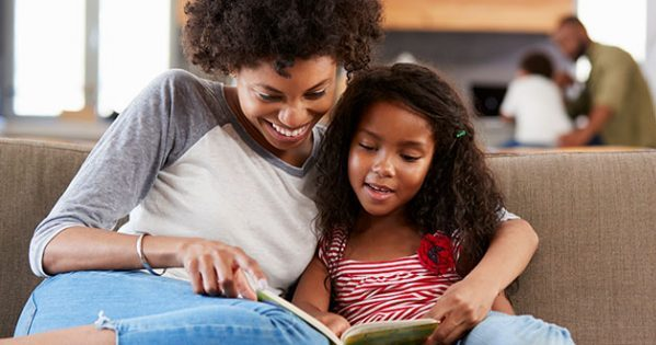 Parent and child discussing new words while reading