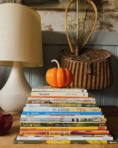 Stack of children's Halloween picture books with pumpkin