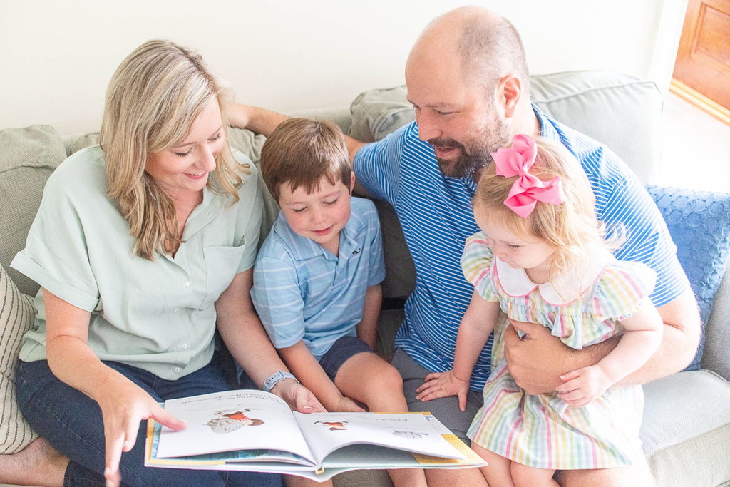 parent child reading together book at home