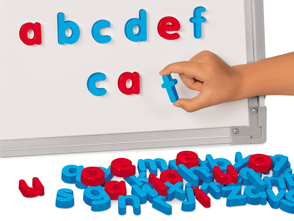 Child building words with magnetic letters