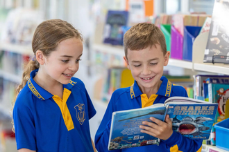 Children exploring shark books and learning about ocean animals.