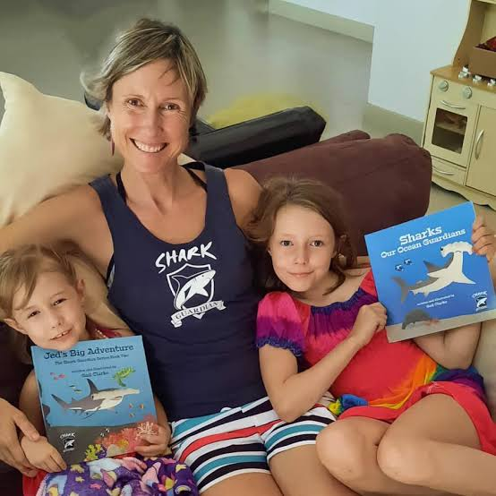 An adult and child reading a picture book together