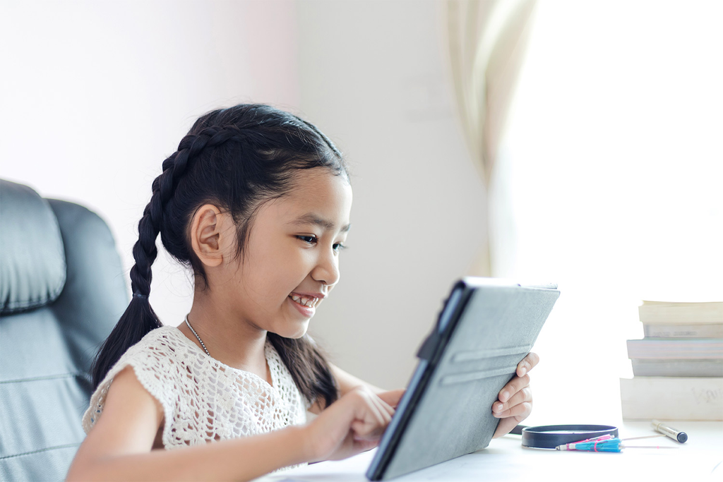 Child reading a digital picture book on a tablet