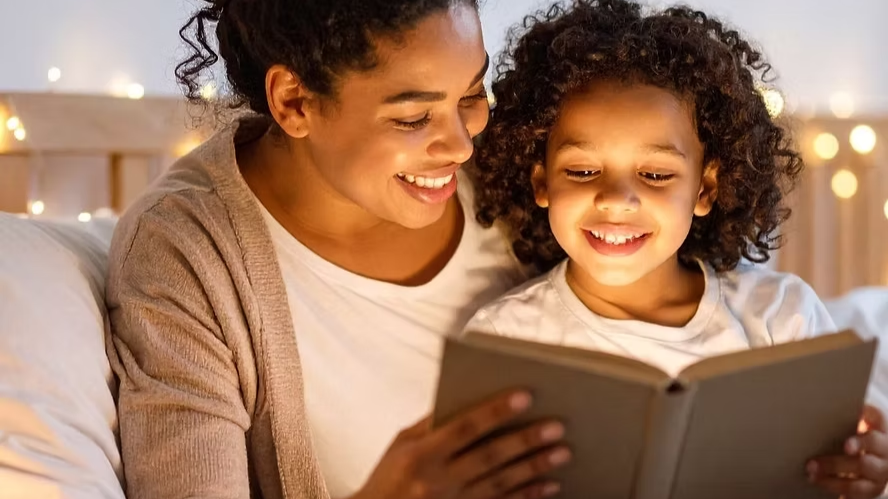 Parent and child reading a space book together